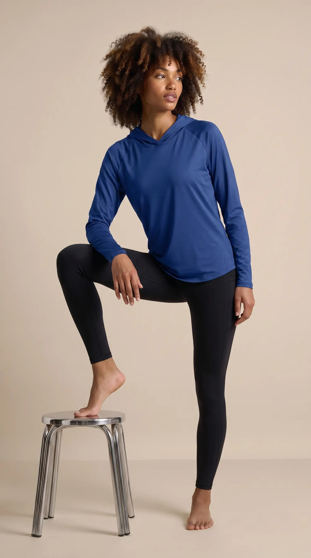Women's hooded sun protection running shirt in blue, showcasing lightweight comfort and style for outdoor activities.