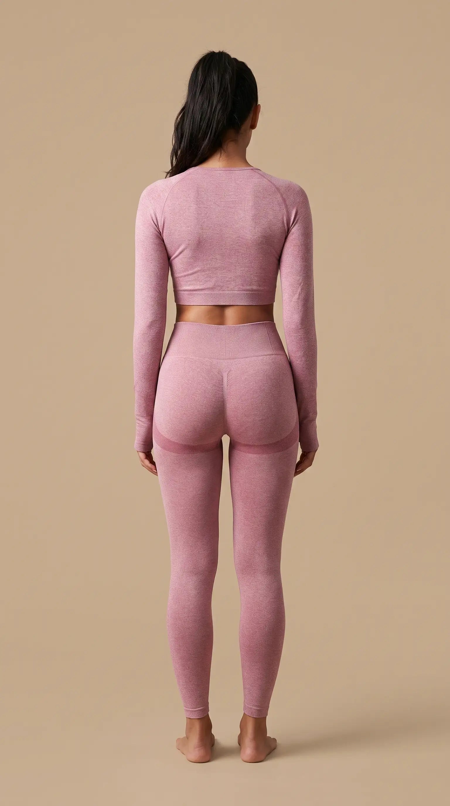 Model wearing New Seamless High Waist Leggings and matching crop top in pink color from the back.