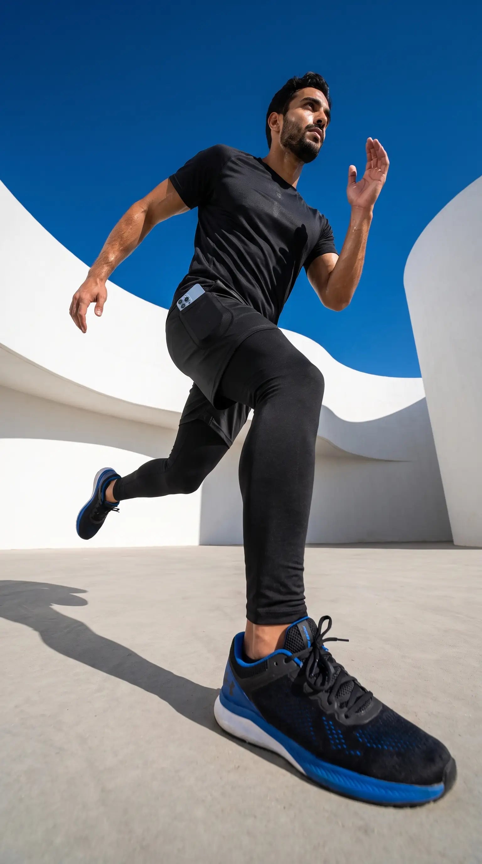 Man wearing Men’s 2-in-1 Quick-Dry Training Pants running on pavement, showcasing athletic performance.