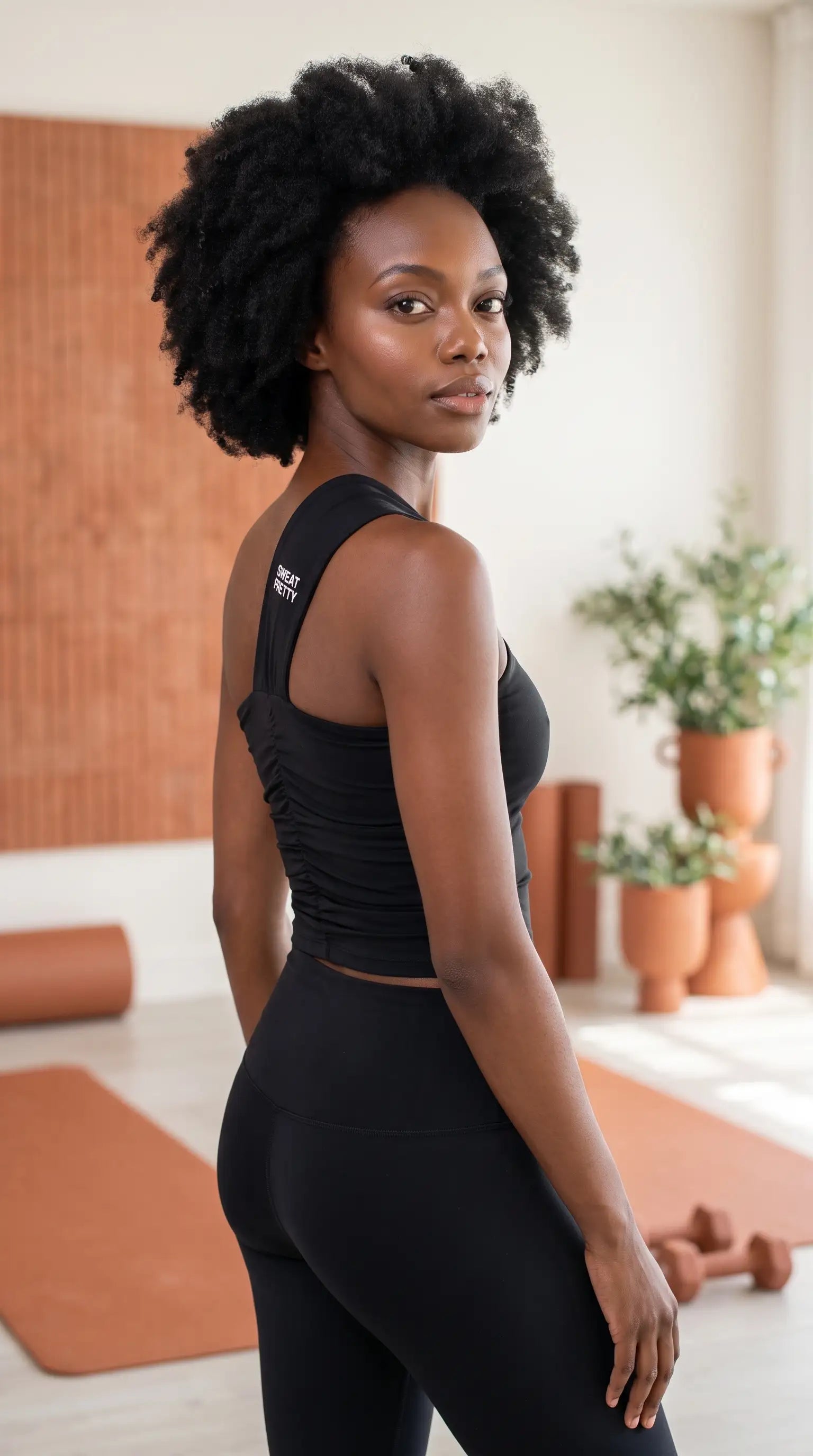 Model wearing the Premium & High-End Teacup Yoga Top in a yoga studio setting.