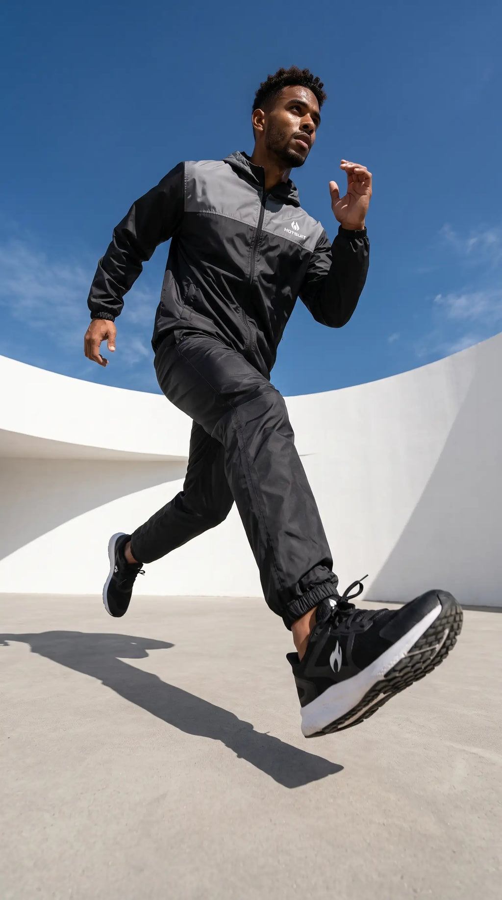 Man running outdoors wearing Men's Full Body Sauna Suit Set for Gym & Cardio, designed for high-performance workouts.