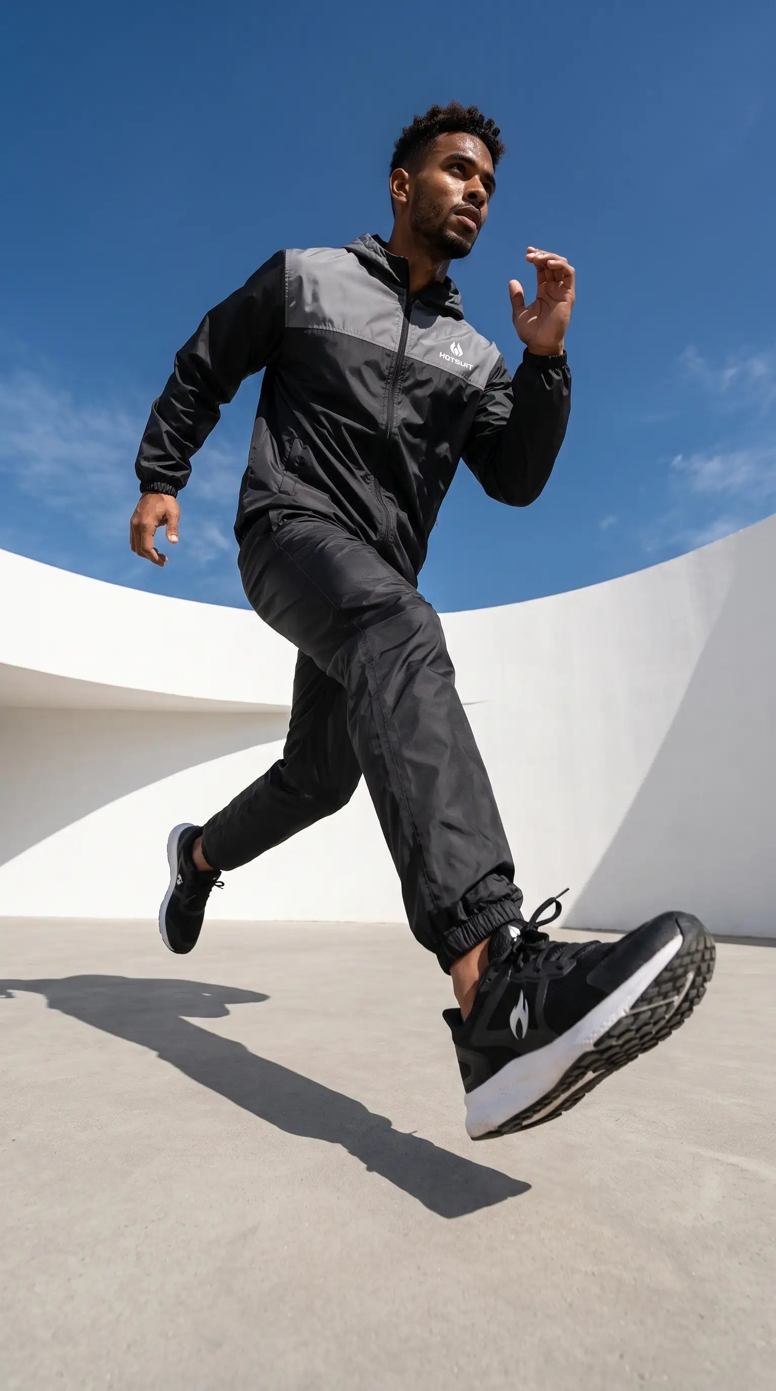Man running outdoors wearing Men's Full Body Sauna Suit Set for Gym & Cardio, designed for high-performance workouts.