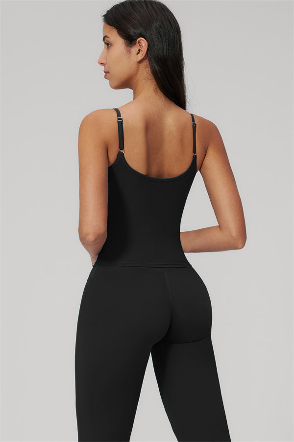 Model showcasing The Rapture Tank Top Flared Leggings 2-Piece Set, seen from behind, wearing a black tank top and leggings.