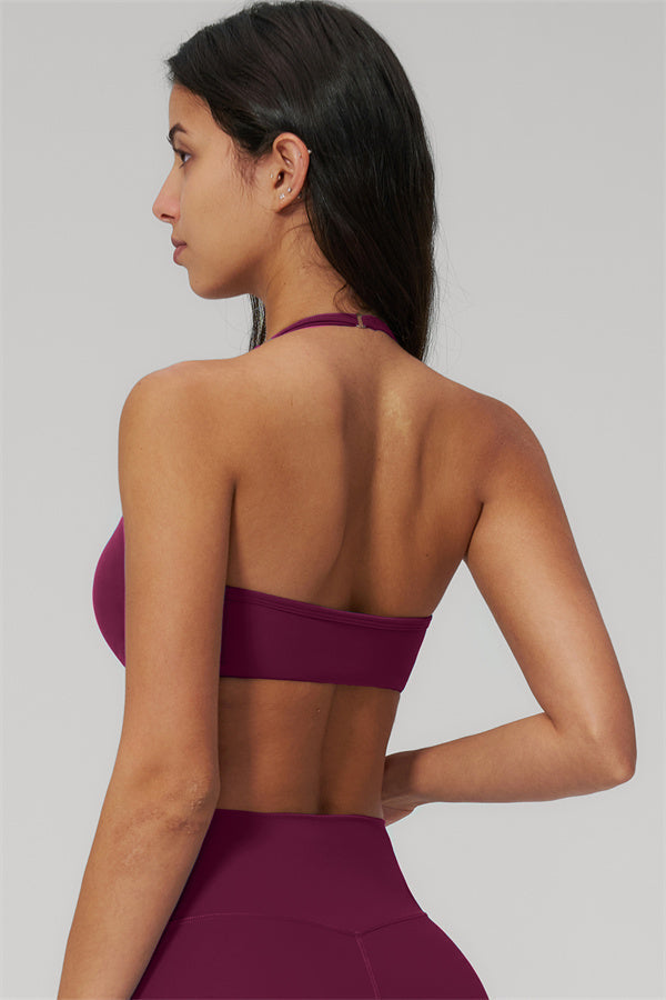 Back view of a woman wearing The Rapture Sports Bra Leggings 2-Piece Set in a rich burgundy color.