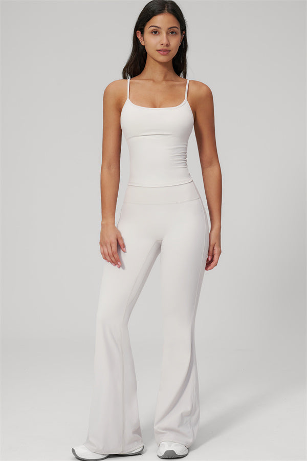 Model wearing The Rapture Tank Top Flared Leggings 2-Piece Set in white, showcasing fitted tank and flared leggings.