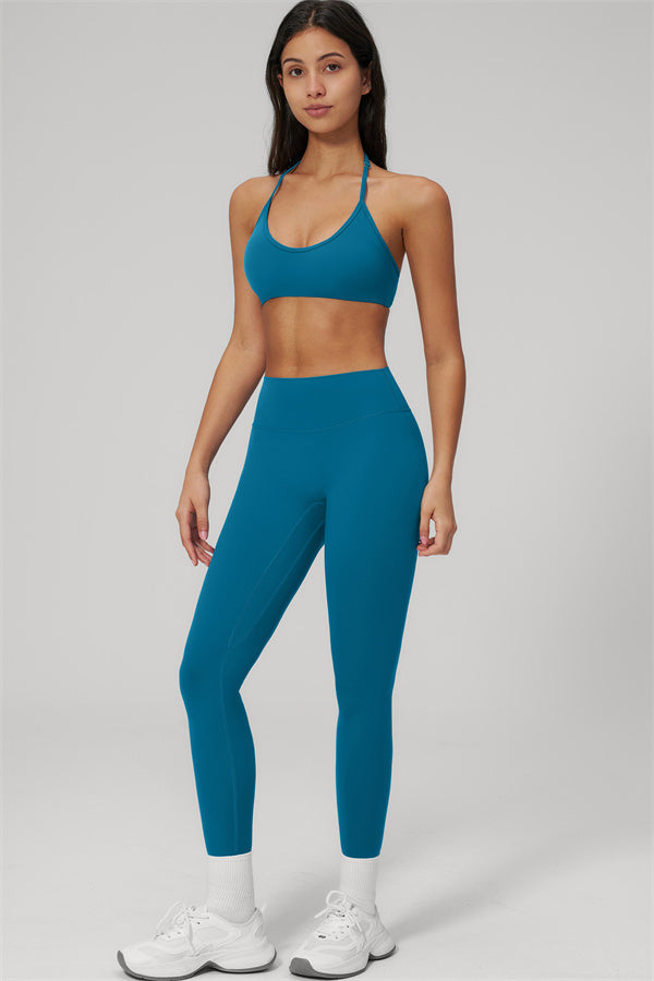 The Rapture Sports Bra Leggings 2-Piece Set featuring a sleek halter bra and high-waisted leggings in teal.