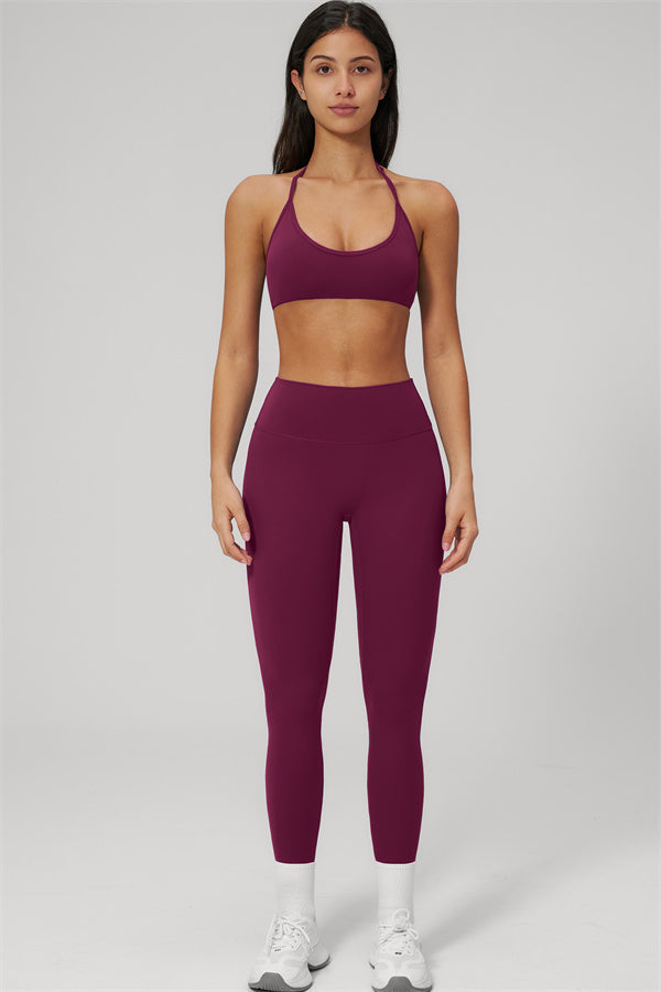 The Rapture Sports Bra Leggings 2-Piece Set on a model showcasing a sleek halter neckline and high-waisted leggings.