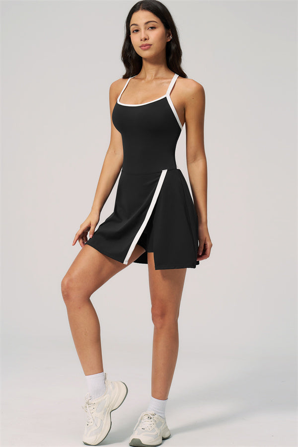 Model wearing The New High End Spunk Tennis Dress, showcasing the stylish black design with white accents.