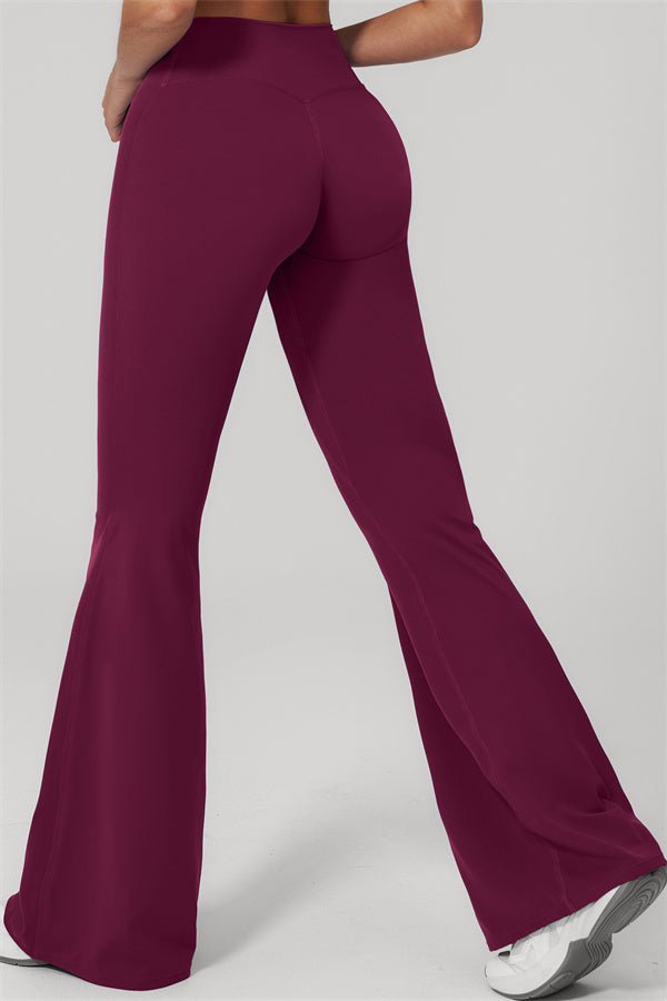 Model showcasing the Rapture Tank Top Flared Leggings 2-Piece Set in flared burgundy leggings from the back.