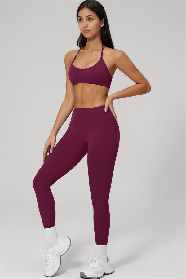 The Rapture Sports Bra Leggings 2-Piece Set featuring a model in a stylish maroon sports bra and high-waisted leggings.