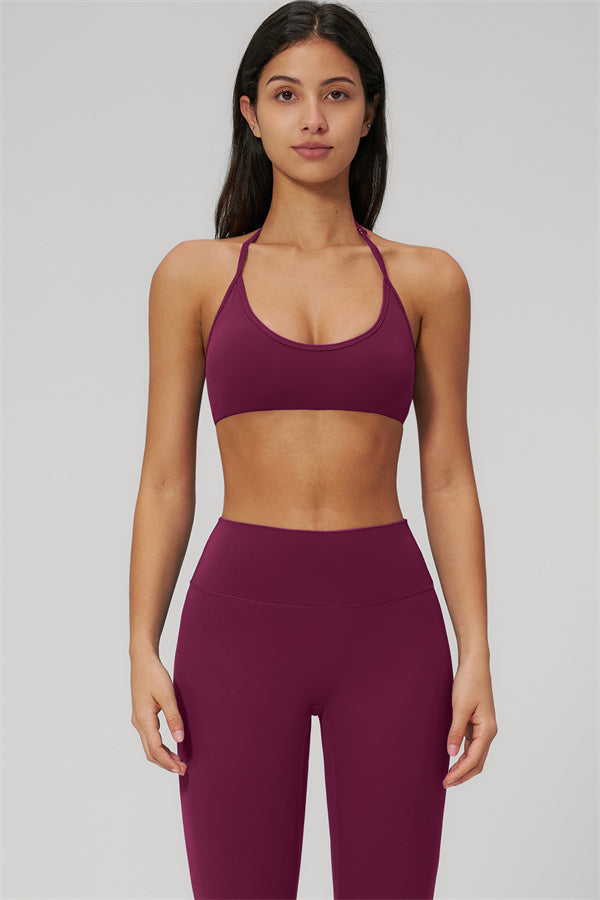 The Rapture Sports Bra Leggings 2-Piece Set in deep burgundy, showcasing a halter sports bra and high-waisted leggings.