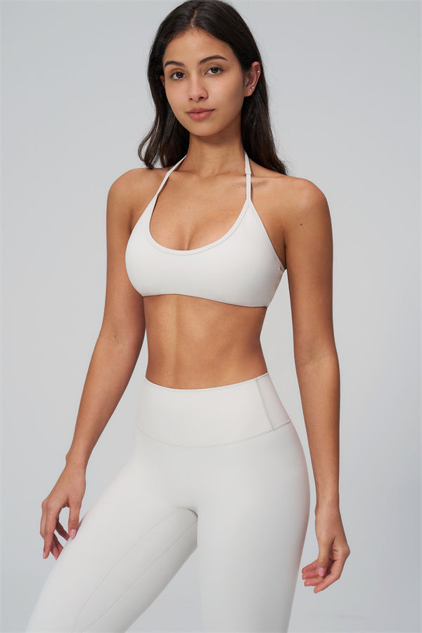 Woman in The Rapture Sports Bra Leggings 2-Piece Set showcasing a sleek white sports bra and high-waisted leggings.