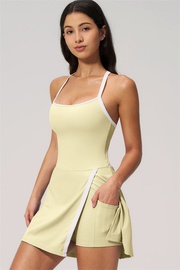 Model wearing The New High End Spunk Tennis Dress in light yellow with a stylish design and a pocket.