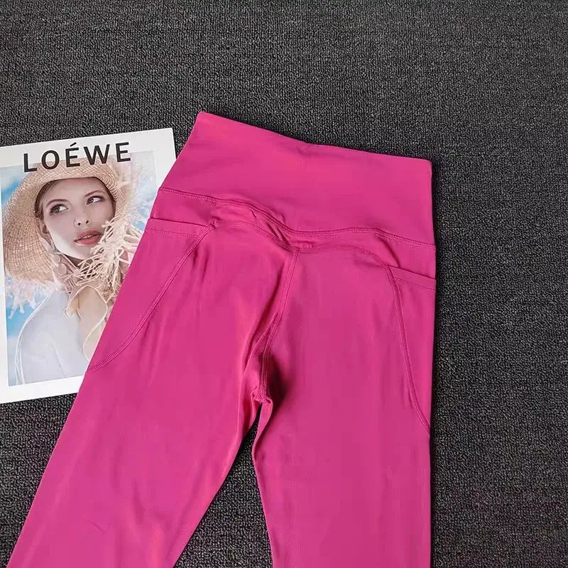 Women’s High-End Yoga Workout Set Pink Leggings on a textured surface with a Loewe magazine in the background