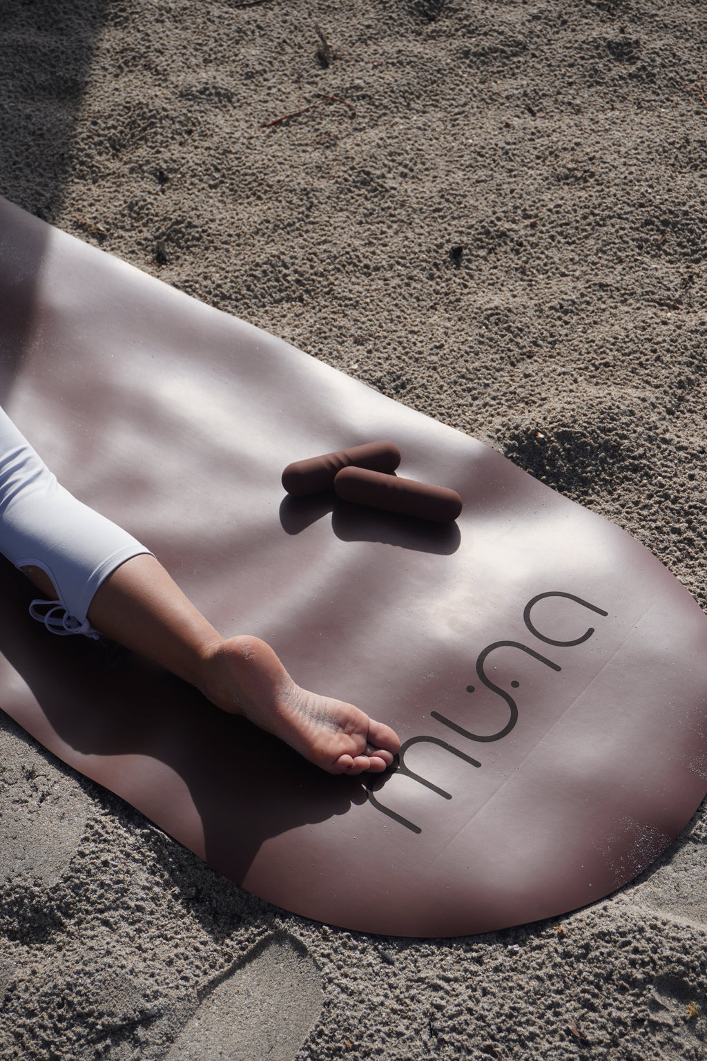 MUNA Oval Yoga Mat on sandy surface demonstrating oval yoga mat for non-slip performance during practice.