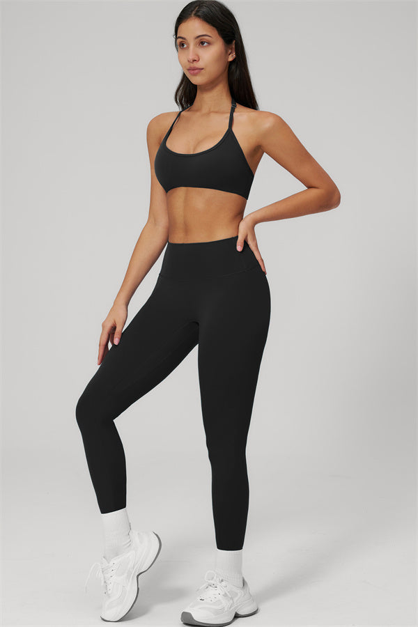 The Rapture Sports Bra Leggings 2-Piece Set featuring a halter neck sports bra and high-waisted leggings in black.