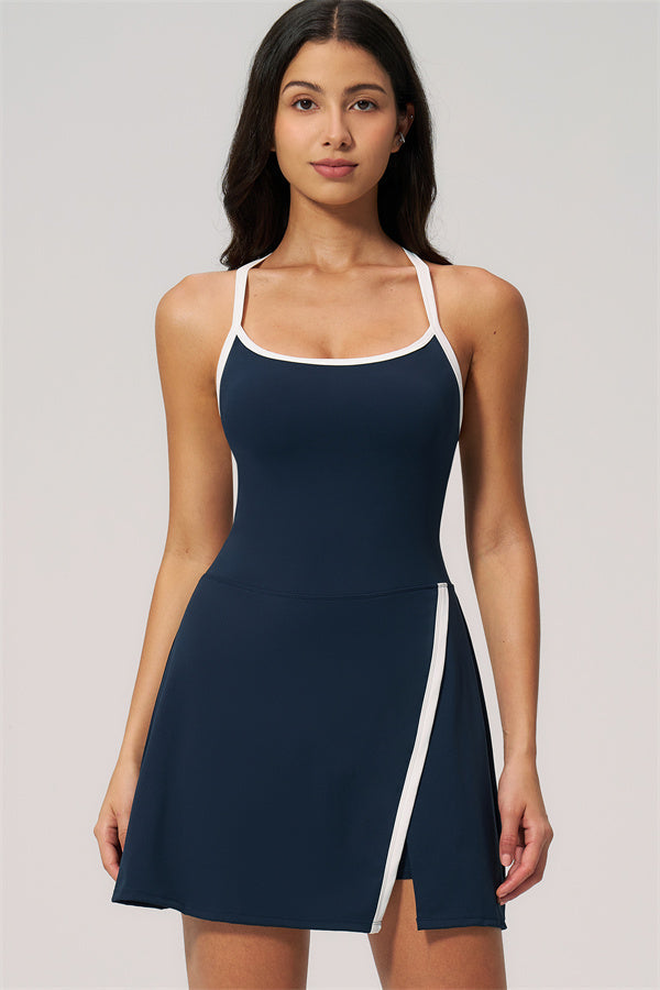 Model wearing The New High End Spunk Tennis Dress in navy with stylish white accents.