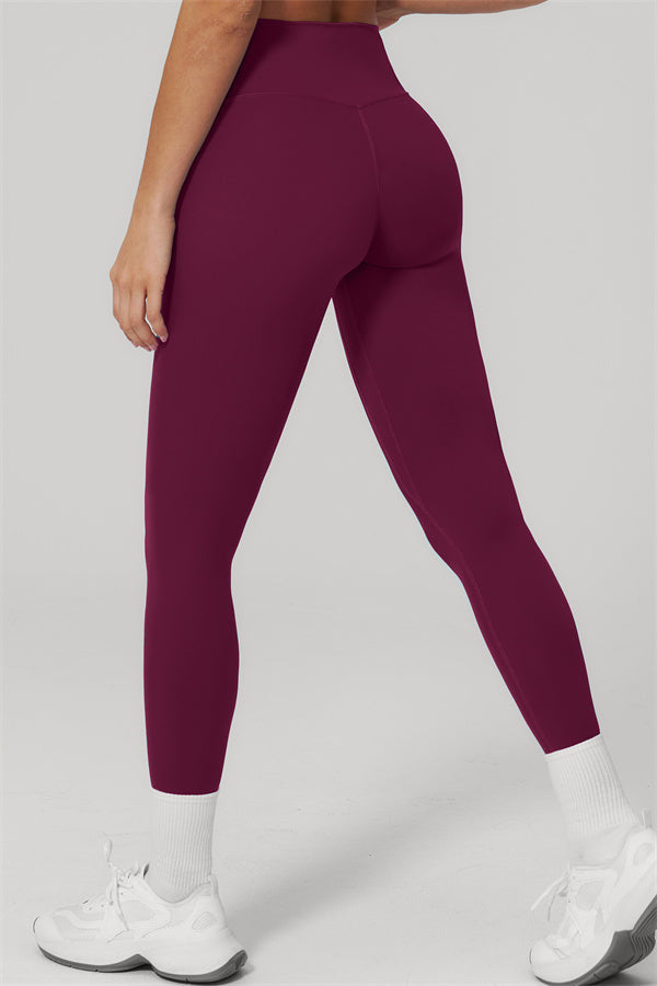 The Rapture Sports Bra Leggings 2-Piece Set featuring high-waisted leggings in a deep burgundy color, showcasing a flattering fit.