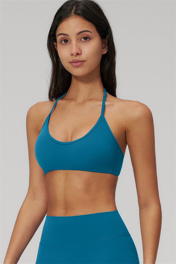 The Rapture Sports Bra Leggings 2-Piece Set model showcasing the stylish blue sports bra with a halter neckline.
