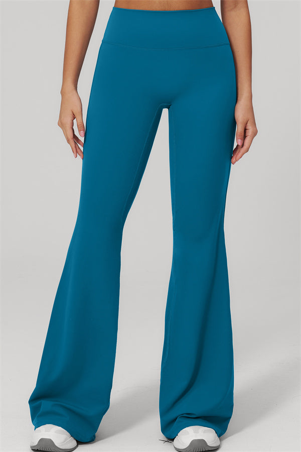 The Rapture Tank Top Flared Leggings 2-Piece Set featuring teal flared leggings modeled by a woman.