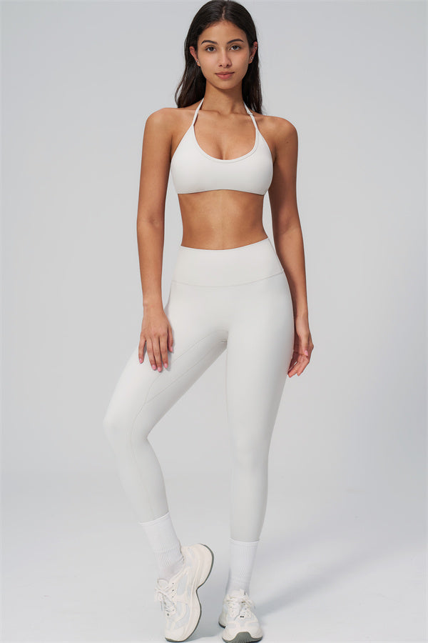 The Rapture Sports Bra Leggings 2-Piece Set displayed on a model, showcasing the bra and high-waisted leggings in white.