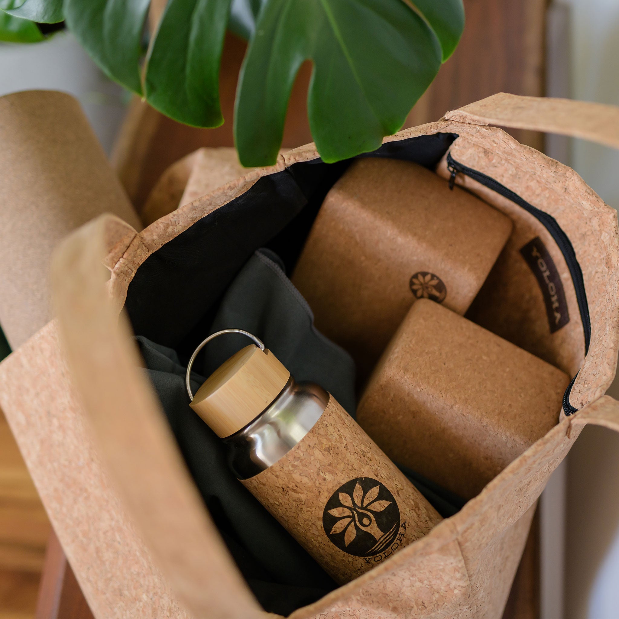 Inside view of Freshly New Designed Cork Tote Bag with yoga mat holder, water bottle, and packing boxes.