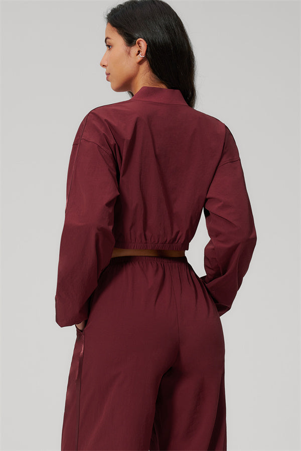 Model showcasing The Spunk UV protection Jacket Sweatpants 2-Piece Set from the back in a burgundy color.
