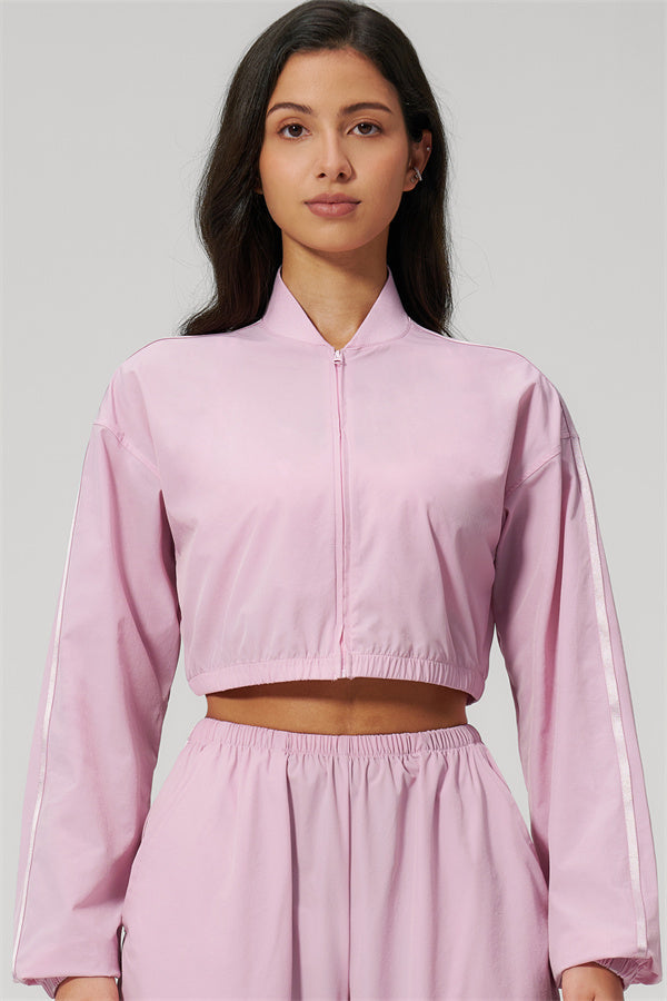 The Spunk UV protection Jacket Sweatpants 2-Piece Set displayed in a pink crop jacket, featuring a sporty design and relaxed fit.