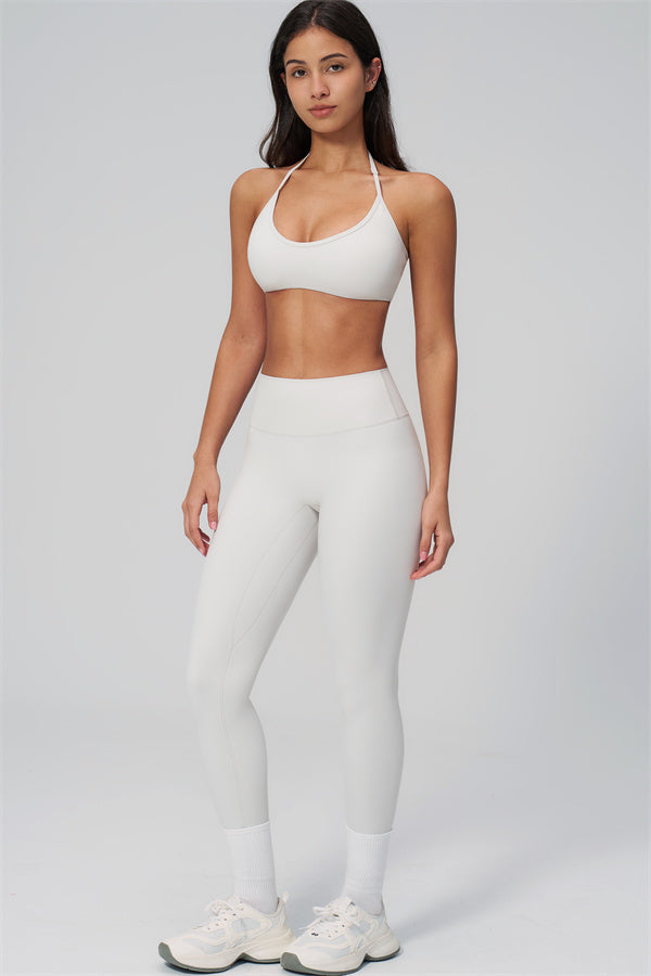 The Rapture Sports Bra Leggings 2-Piece Set displaying a model in a white sports bra and high-waisted leggings.