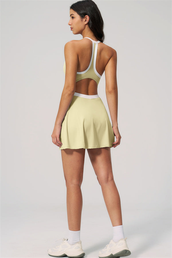 Back view of The New High End Spunk Tennis Dress in light yellow with a sleek cut and sporty design.