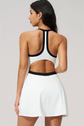 Model showcasing the back view of The New High End Spunk Tennis Dress in white with black accents.