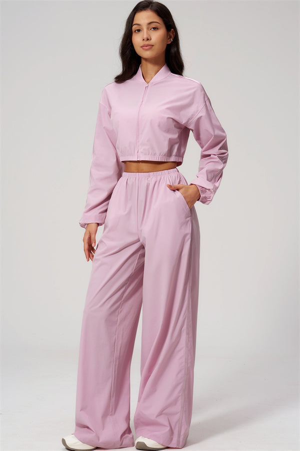 The Spunk UV protection Jacket Sweatpants 2-Piece Set in pink worn by a model, showcasing sporty style and comfort.