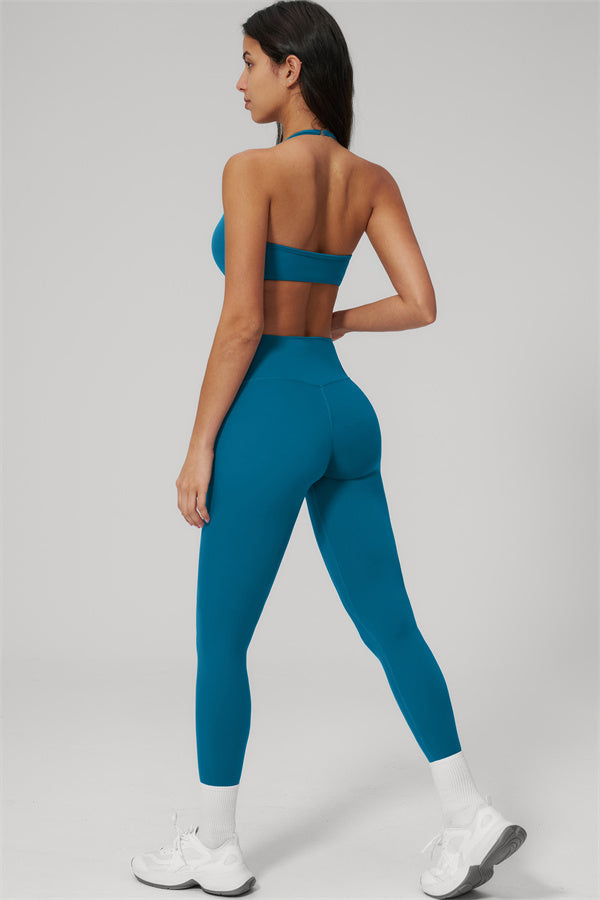 The Rapture Sports Bra Leggings 2-Piece Set in teal, showcasing halter sports bra and high-waisted leggings from the back.