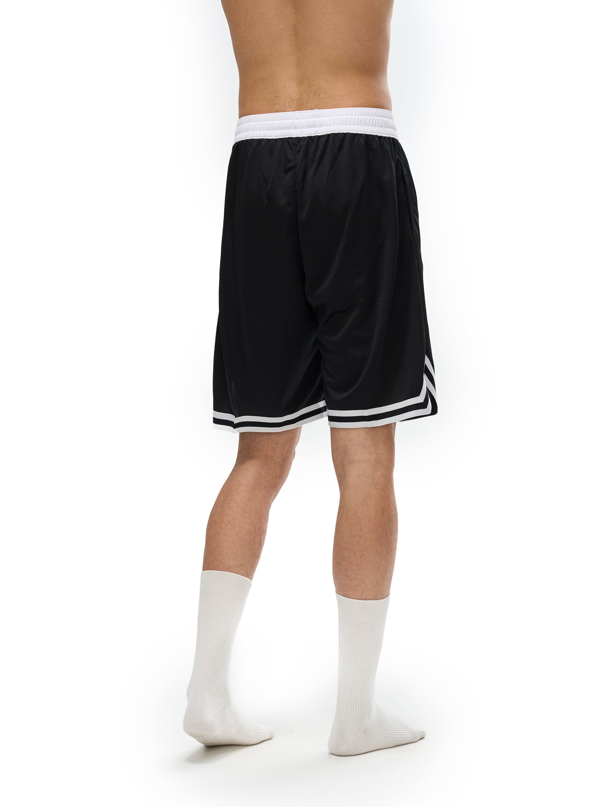 Back view of a model wearing Loki & Ivy Classic Stripe Trim Basketball Shorts, featuring a black design with stripe trim.